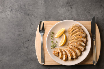 Tasty fresh lemon chicken served on grey table, top view.Space for text