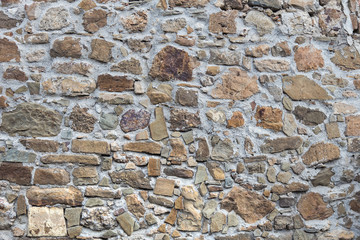 Stone wall of rough unprocessed stones