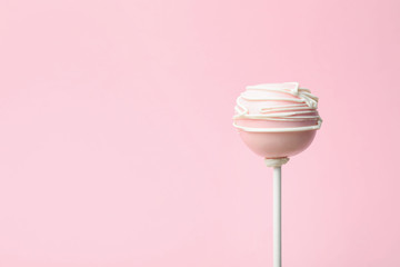 Sweet decorated cake pop on pink background, space for text