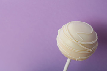 Sweet cake pop on purple background, space for text