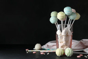 Sweet cake pops on table against black background. Space for text