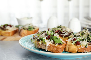 Delicious bruschettas with beef and cheese on marble table, closeup