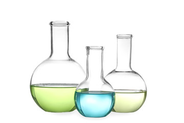 Glassware with liquids isolated on white. Laboratory analysis