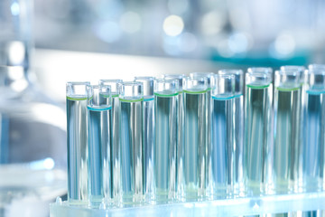 Test tubes with liquid samples for analysis in laboratory, closeup
