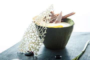 closeup original dessert of baked avocado decorated with chocolate