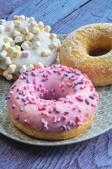 Sweet colorful dessert. Donut with a hole and pink delicious icing.