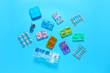 Containers with different pills on color background