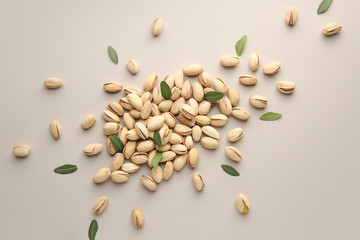 Tasty pistachio nuts on grey background