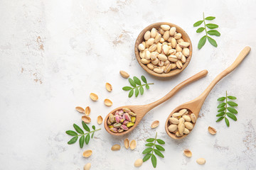 Fototapeta na wymiar Tasty pistachio nuts on white background