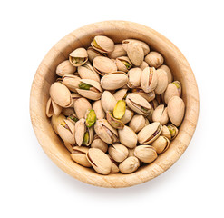 Bowl with tasty pistachio nuts on white background