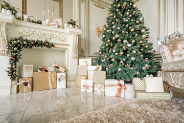 Christmas morning. Classic luxurious apartments with decorated christmas tree and presents. Living with fireplace, columns and stucco.
