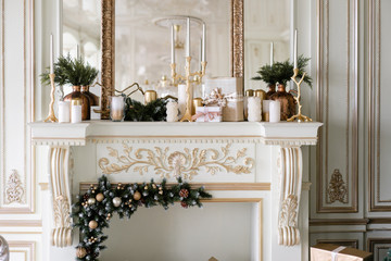 Christmas morning. Classic luxurious apartments with decorated christmas tree and presents. Living with fireplace, columns and stucco.