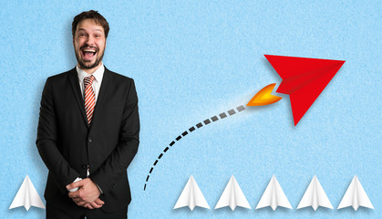 businessman with little airplanes and a red one symbolizing a different approach 