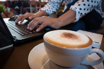 Women working in coffee shops have coffee cup, laptop, calculator and documents. Startup and Freelance concept