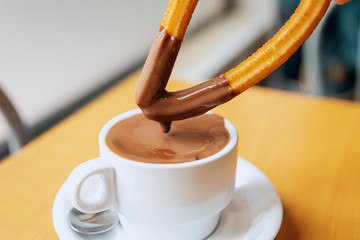 dipped churro in hot chocolate