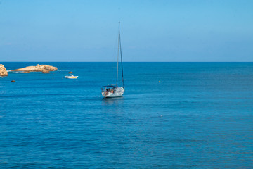 Fototapeta premium Sailing yacht in the blue sea. Ship yacht sails in the open Sea. Luxury boats. Crete, Greece. Aegean sea. Copy Space.