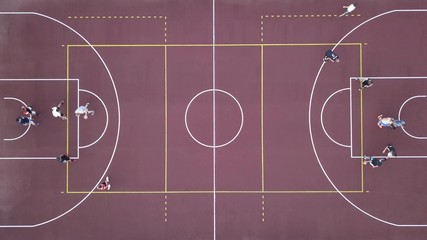 Men play basketball on the brown field. 4K video, 240fps, 2160p.
