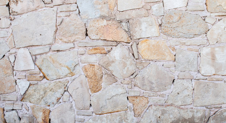 Texture of a stone wall. Old stone wall texture background. Stone wall as a background or texture. Greek stone wall.