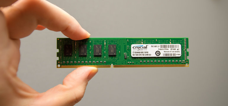 LONDON, UK - DEC 29, 2018: Man holding in hand new powerful RAM manufactured by Crucial by Micron for powerful servers and workstations in data centers