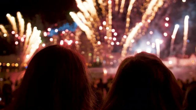 People look at the fireworks show on holiday in the evening at night