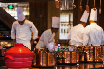 Traditional preparing food and professional Chinese cooks at kitchen.