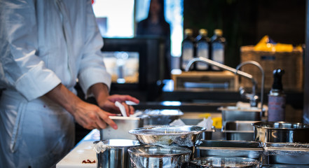 Traditional preparing food and professional Chinese cooks at kitchen.