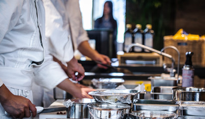 Traditional preparing food and professional Chinese cooks at kitchen.