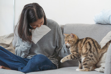 Woman sneezing from pets allergy. 