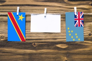 Hanging flags of Congo and Tuvalu attached to rope with clothes pins with copy space on white note...