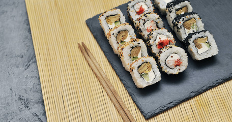 Japanese rolls on stone background.