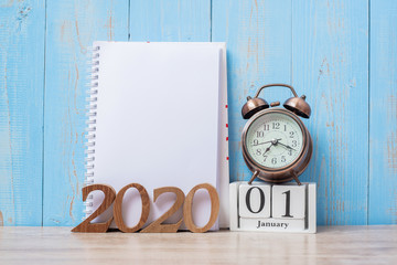 2020 Happy New Year  with blank notebook, retro alarm clock and wooden number. New Start, Resolution, Goals, Plan, Action and Mission Concept