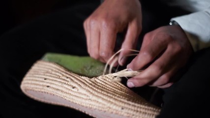 Close up of man making rafia shoes in Marrakech, Morocco