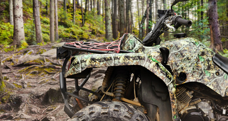 Atv vehicle standing in forest close-up view. © breakermaximus