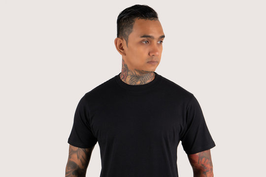 Young Man Wearing Black Plain T Shirt Isolated On White Background. Hipster Man With Tattoo Wearing Black T Shirt. Ready For Mock Up Design Template Or Background. Portrait Of Man With Tattoo.
