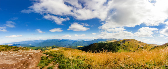 Landscape photo of mountain hills with blue sunny day sky.