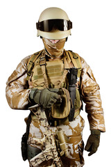 Isolated soldier in uniform standing in desert background.