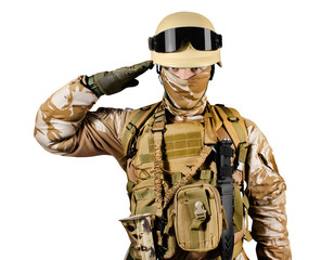 Soldier in uniform standing in desert saluting.