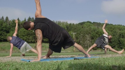 Yoga Lesson in the Park - Male Yogi with Two Male Students