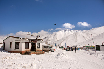 Indian and traveler people stop car rest at check point base camp on Khardung La Road in Himalaya mountain at Leh Ladakh in Jammu and Kashmir, India