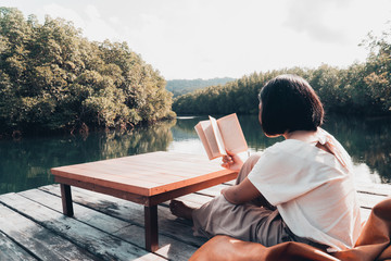 Fototapeta premium Woman reading a book, hobby and resting concept.