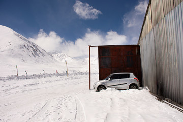 Indian people stop car in garage of check point base camp on Khardung La Road in Himalaya mountain at Leh Ladakh in Jammu and Kashmir, India