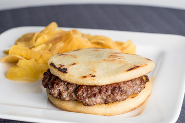 arepa with meat and fried green banana
