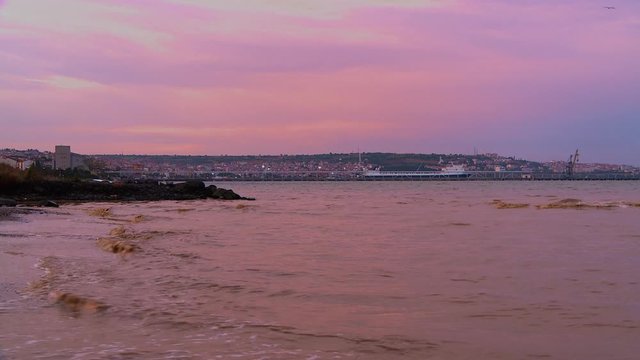 Dirty waves at shore, Tekirdağ in the background, Turkey.