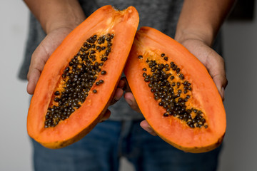 man hands holding fresh papaya