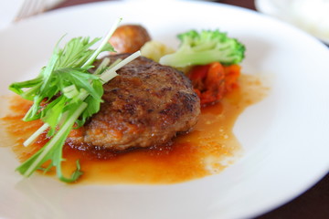 Minced steak and vegetables on a white plate.