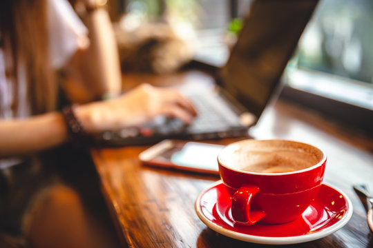 Mock up of a cup of cold coffee on wood table and had blur nature.. Mock up of a cup of cold coffee on wood table and had blur nature..