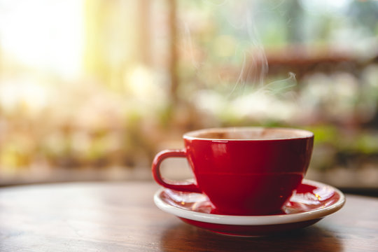 Mock up of a cup of cold coffee on wood table and had blur nature.. Mock up of a cup of cold coffee on wood table and had blur nature..