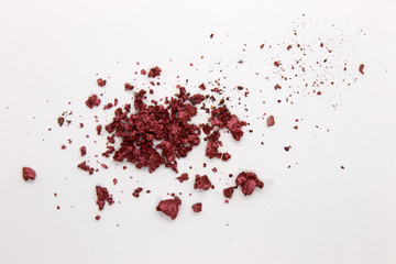 This is a photograph of a Metallic Burgundy Powder Eyeshadow isolated on a White Background
