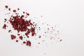 This is a photograph of a Metallic Burgundy Powder Eyeshadow isolated on a White Background
