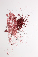 This is a photograph of Metallic Pink and Burgundy Powder Eyeshadow isolated on a White Background